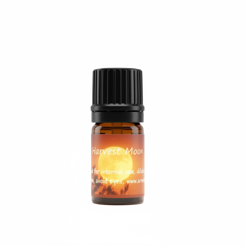 A small amber glass bottle with a black ribbed cap, centered on a plain white background. The label reads 'Harvest Moon' with a warm glowing sun graphic and smaller text below.