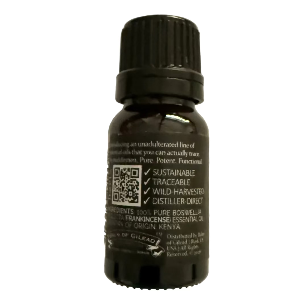 Bottle of frankincense essential oil on a plain background